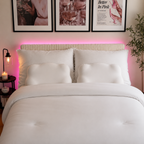 Bedroom with a bed, nightstands, and framed pictures on the wall.