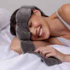 Woman wearing a gray towel on her head while lying in bed