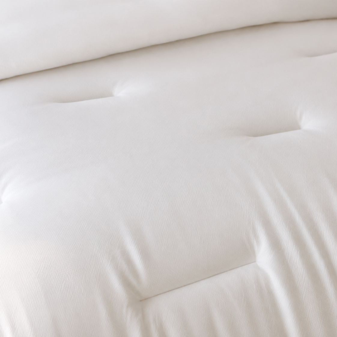 Close-up of a white mattress with a soft texture
