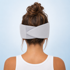 Person wearing a gray headband against a light blue background