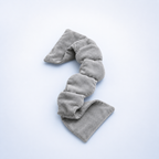 Gray fabric sleep mask on a light blue background