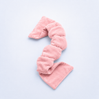 Pink weighted eye mask on a light purple background