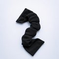 Black weighted eye mask for sleeping on a white background